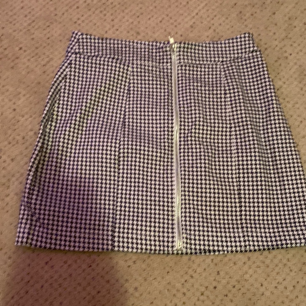 Multicolored/ black and white patterned. Size small. Silver front zipper.